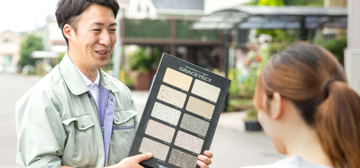 顧客にカラーサンプルを提示するスタッフ